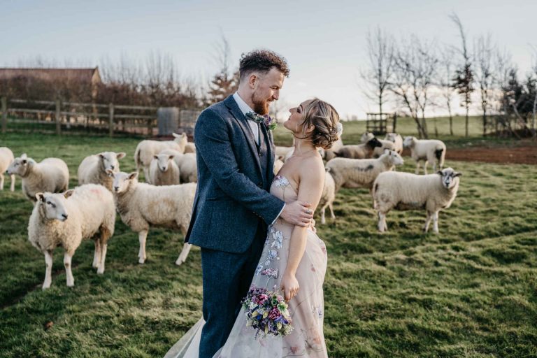 Paige + Ash's wedding day at Dodford Manor featuring a colourful hand painted wedding dress by Savin London