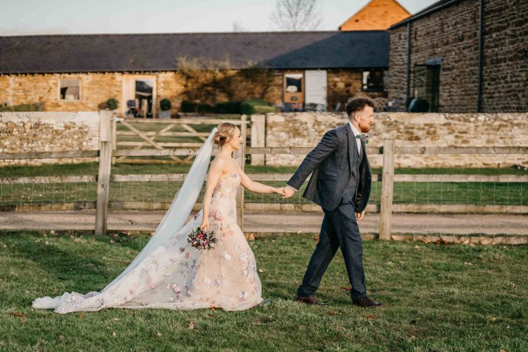 Paige + Ash's wedding day at Dodford Manor featuring a colourful hand painted wedding dress by Savin London