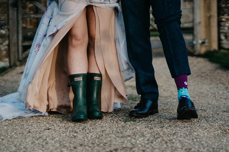 Paige + Ash's wedding day at Dodford Manor featuring a colourful hand painted wedding dress by Savin London