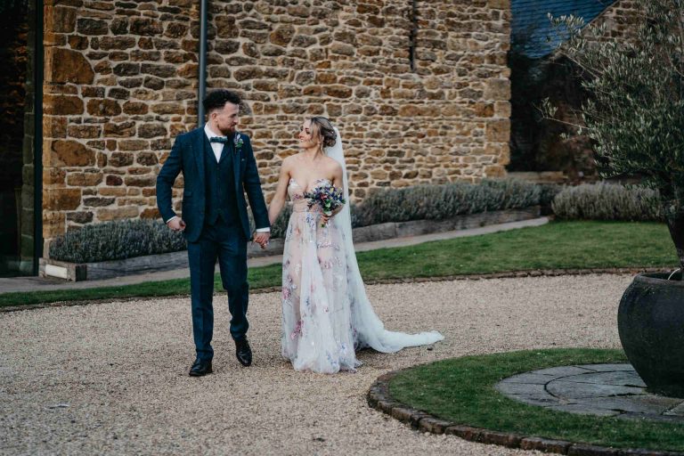 Paige + Ash's wedding day at Dodford Manor featuring a colourful hand painted wedding dress by Savin London