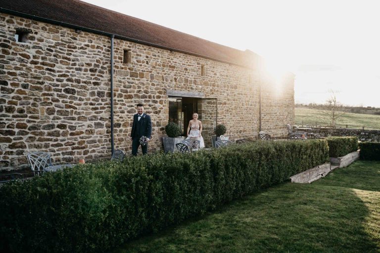 Paige + Ash's wedding day at Dodford Manor featuring a colourful hand painted wedding dress by Savin London
