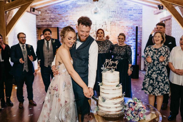 Paige + Ash's wedding day at Dodford Manor featuring a colourful hand painted wedding dress by Savin London