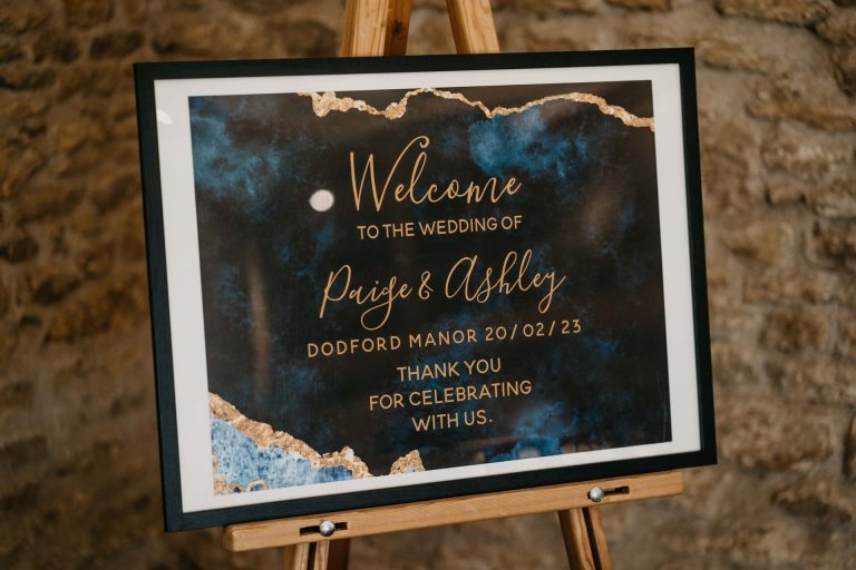 Paige + Ash's wedding day at Dodford Manor featuring a colourful hand painted wedding dress by Savin London