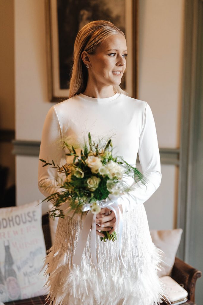 A Nadine Merabi skirt with hand beaded embellishments and a dramatic feather trim for an intimate urban wedding