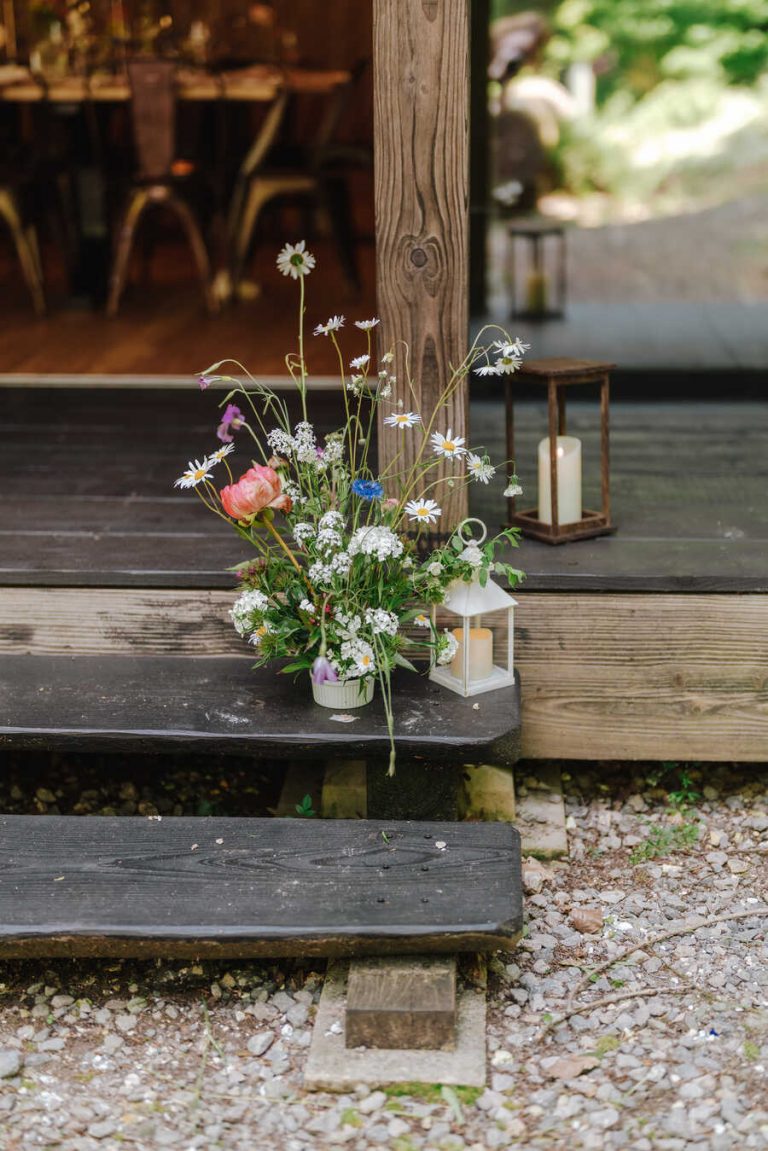 Understated styling with a hint of wildflowers for an intimate woodland wedding