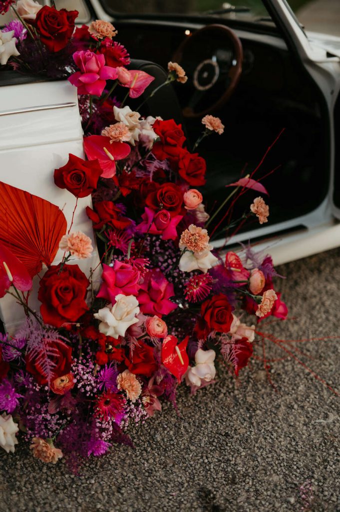 The ultimate wedding photo opportunity backdrop - a flower filled Classic triumph car