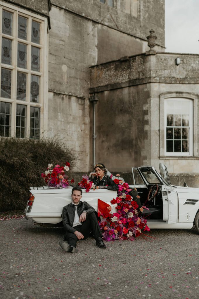 The ultimate wedding photo opportunity backdrop - a flower filled Classic triumph car
