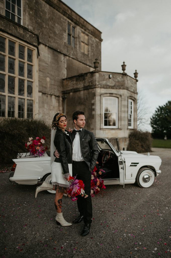 The ultimate wedding photo opportunity backdrop - a flower filled Classic triumph car