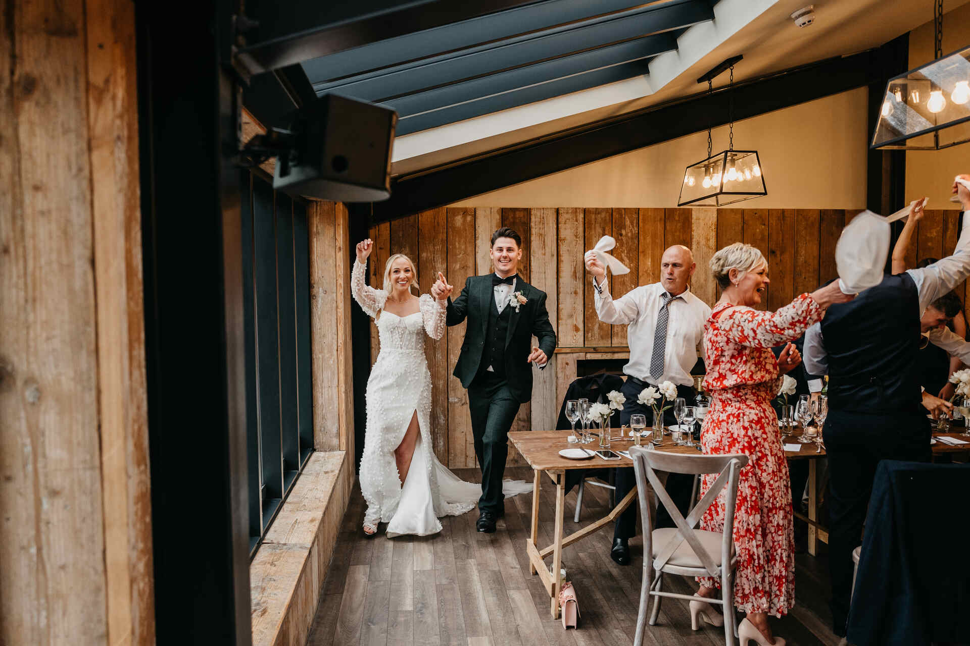 A napkin waving celebration to welcome in the newlyweds at Foxtail Barns