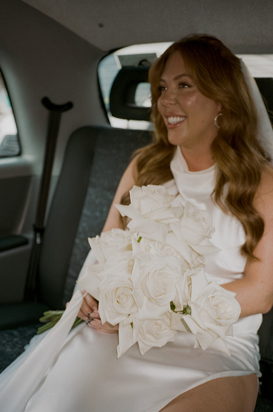 Bride Angelique's elegant all white bridal bouquet of roses