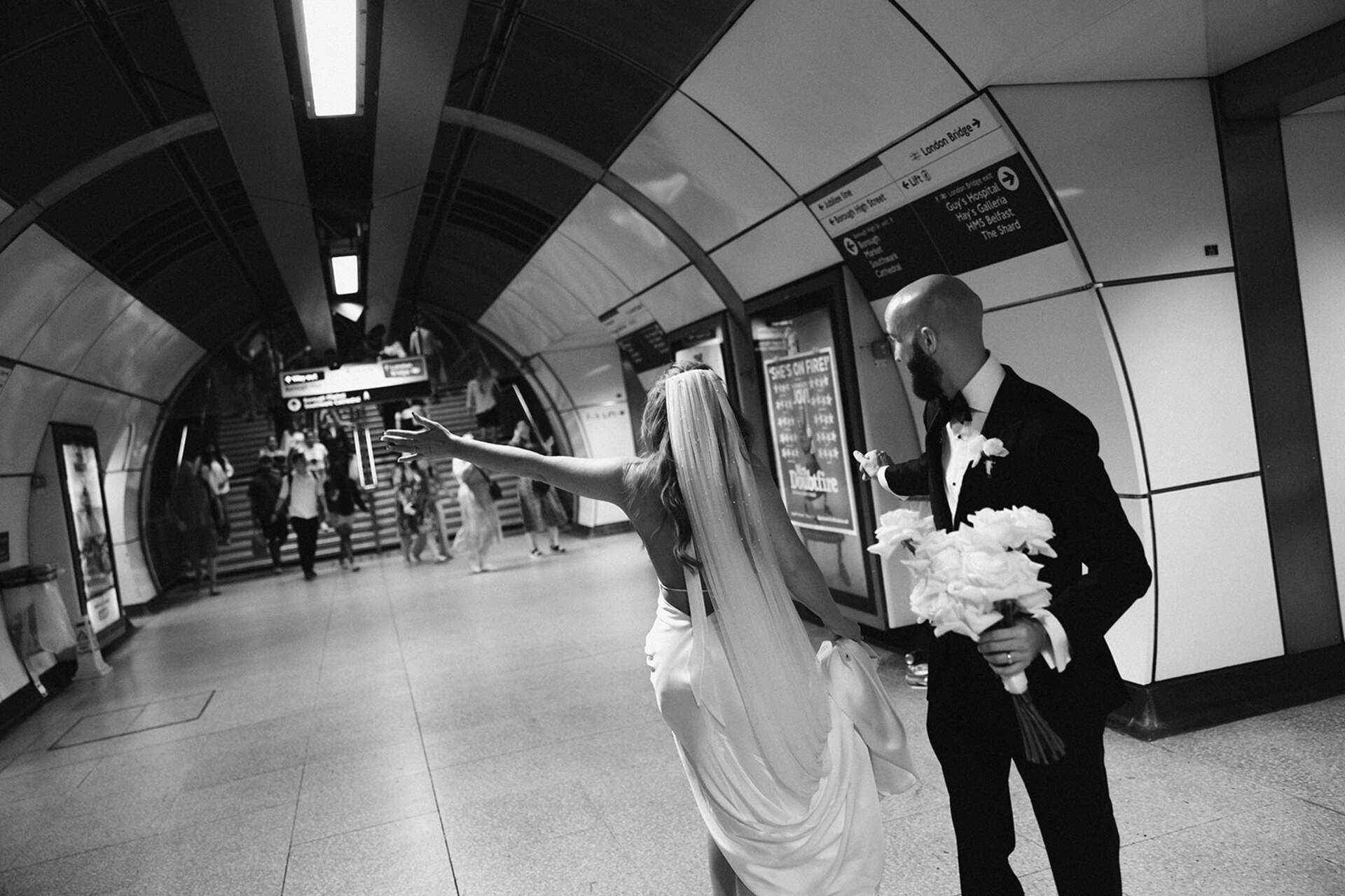 Having fun on the London Underground during an impromptu tube session during a laid back city wedding