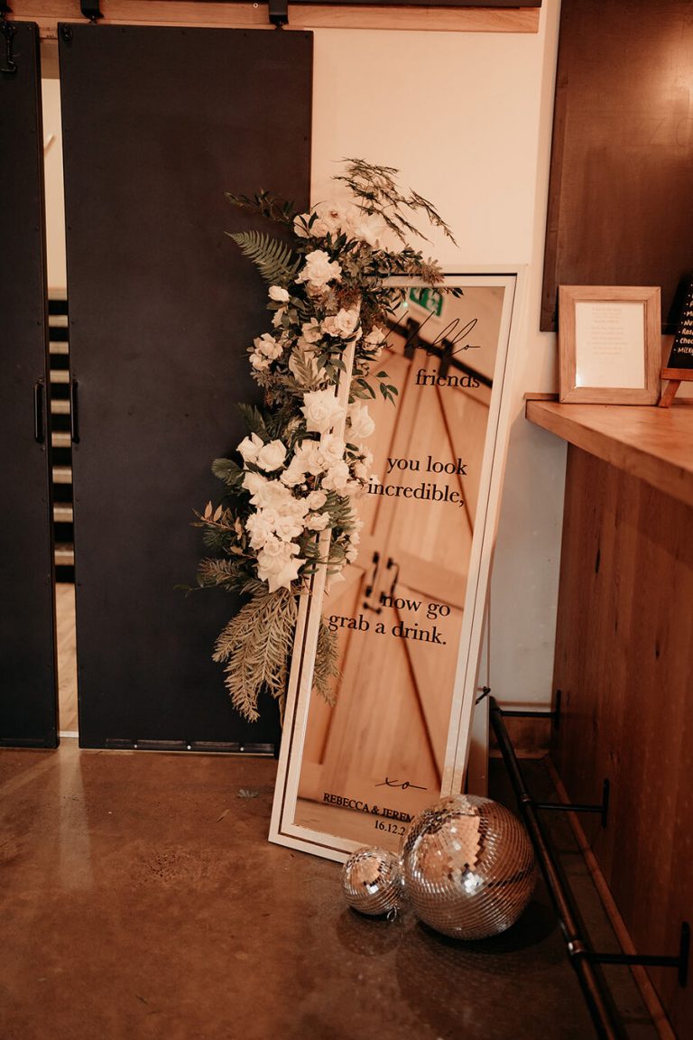 Elegant, contemporary winter wedding styling at Devonshire's Upton Barn with a green and white palette and a mass of mirror balls