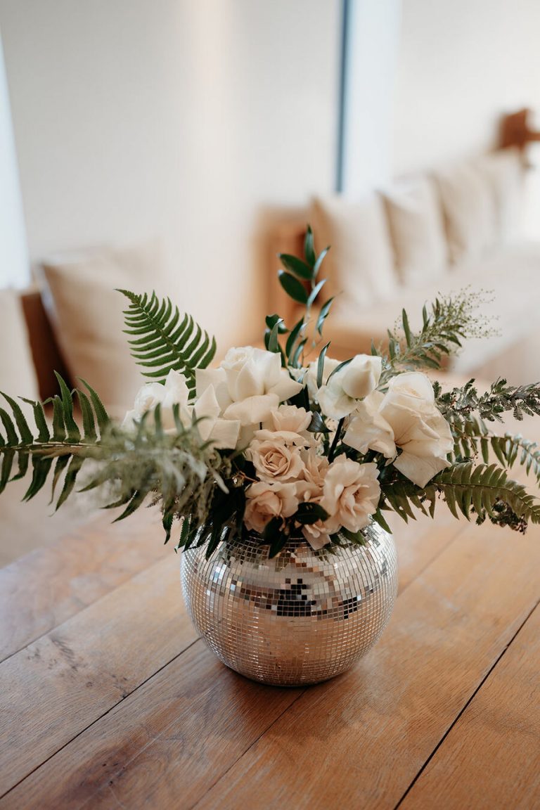 Elegant, contemporary winter wedding styling at Devonshire's Upton Barn with a green and white palette and a mass of mirror balls