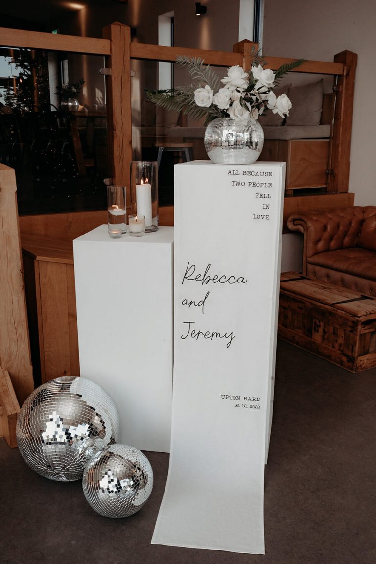 Elegant, contemporary winter wedding styling at Devonshire's Upton Barn with a green and white palette and a mass of mirror balls