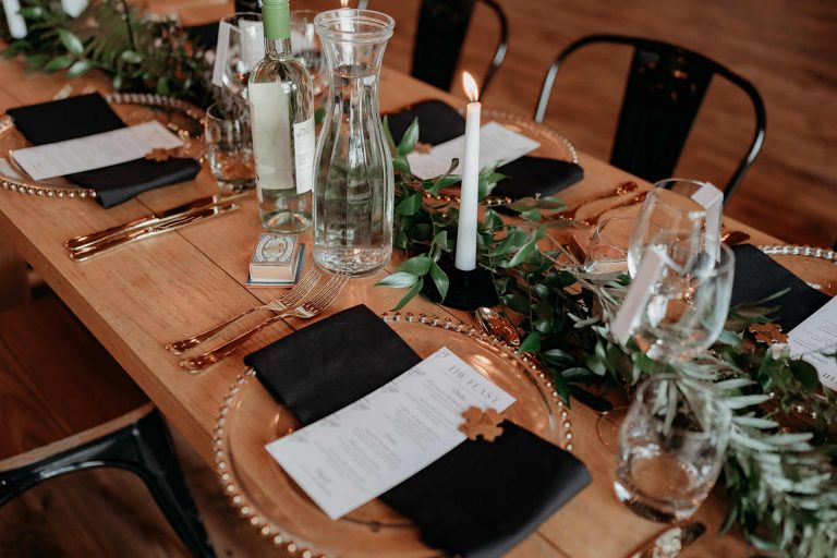 Elegant, contemporary winter wedding styling at Devonshire's Upton Barn with a green and white palette and a mass of mirror balls
