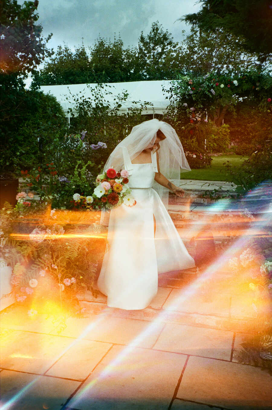 Summer bride Sophie looking radiant in a two piece custom made Jesus Peiro bridal outfit of a sleeveless top and skirt.