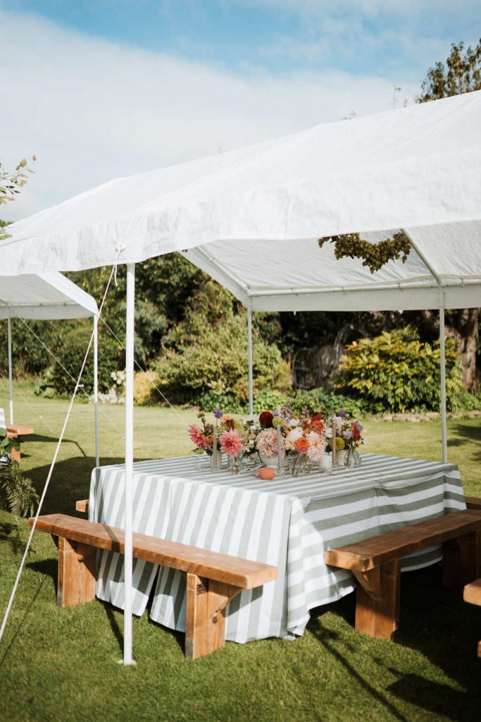Gloriously colourful fresh blooms for a laid-back summer garden party wedding