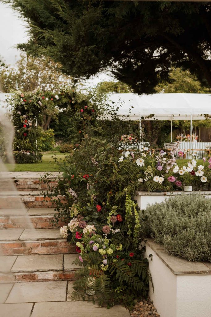 Gloriously colourful fresh blooms for a laid-back summer garden party wedding