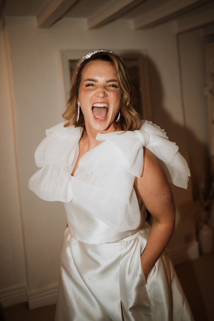Summer bride Sophie looking radiant in a two piece custom made Jesus Peiro bridal outfit of a sleeveless top and skirt.