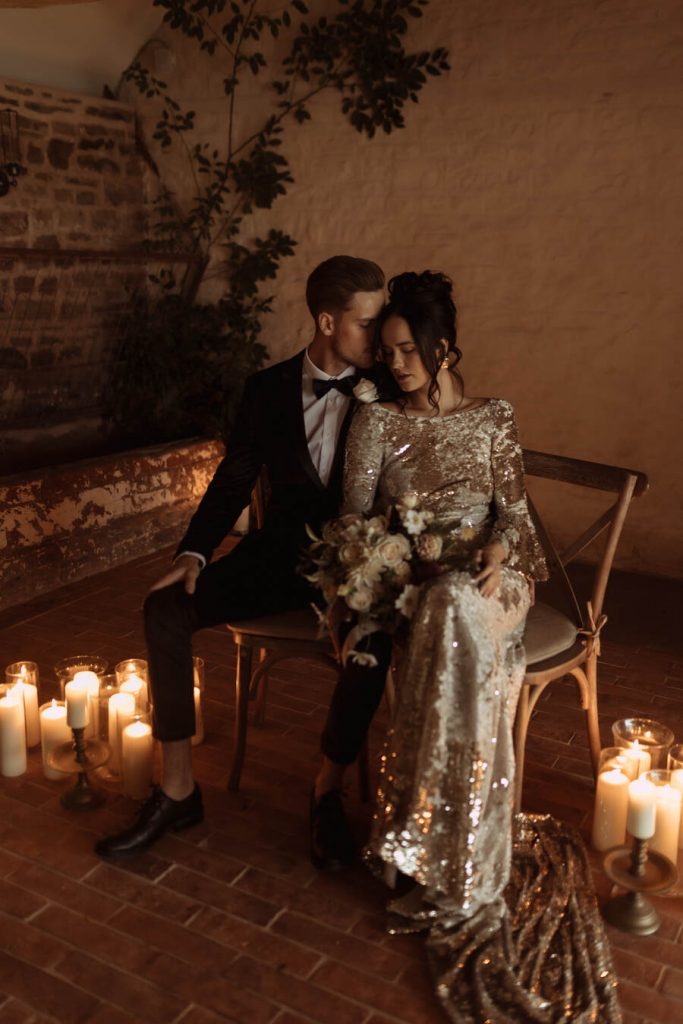 A dreamily romantic candle lit wedding ceremony with Julita London's shimmering Gilded Lily dress the star of the show