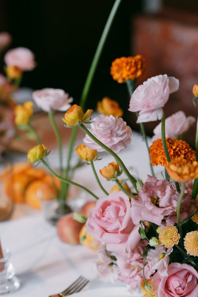 Colourful wedding scenes in a zesty palette of pinks, oranges and yellows at London's Yaatra Restaurant | Lynn Shapiro Photography