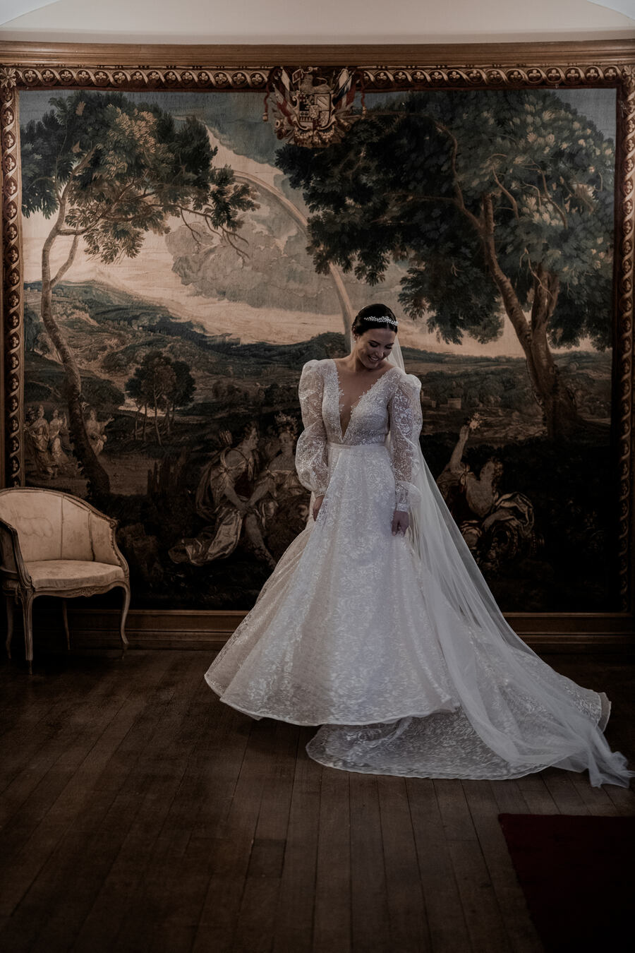 Beautiful bride Gil wearing a stunning Julie Vino long sleeved, puff shouldered, plunging v neck wedding dress with shimmering embroidered embellishments