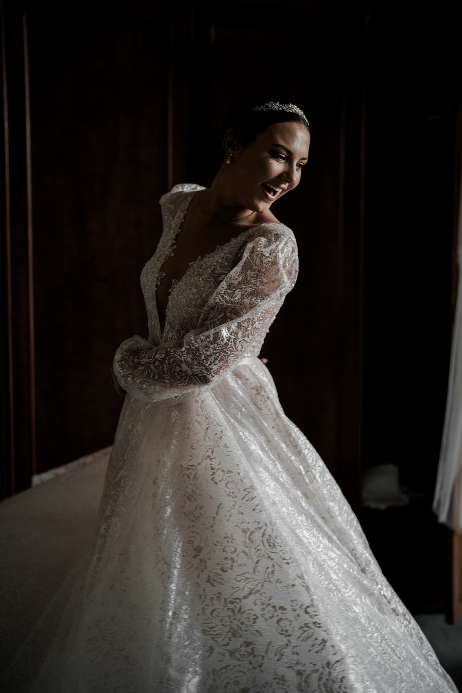 Beautiful bride Gil wearing a stunning Julie Vino long sleeved, puff shouldered, plunging v neck wedding dress with shimmering embroidered embellishments