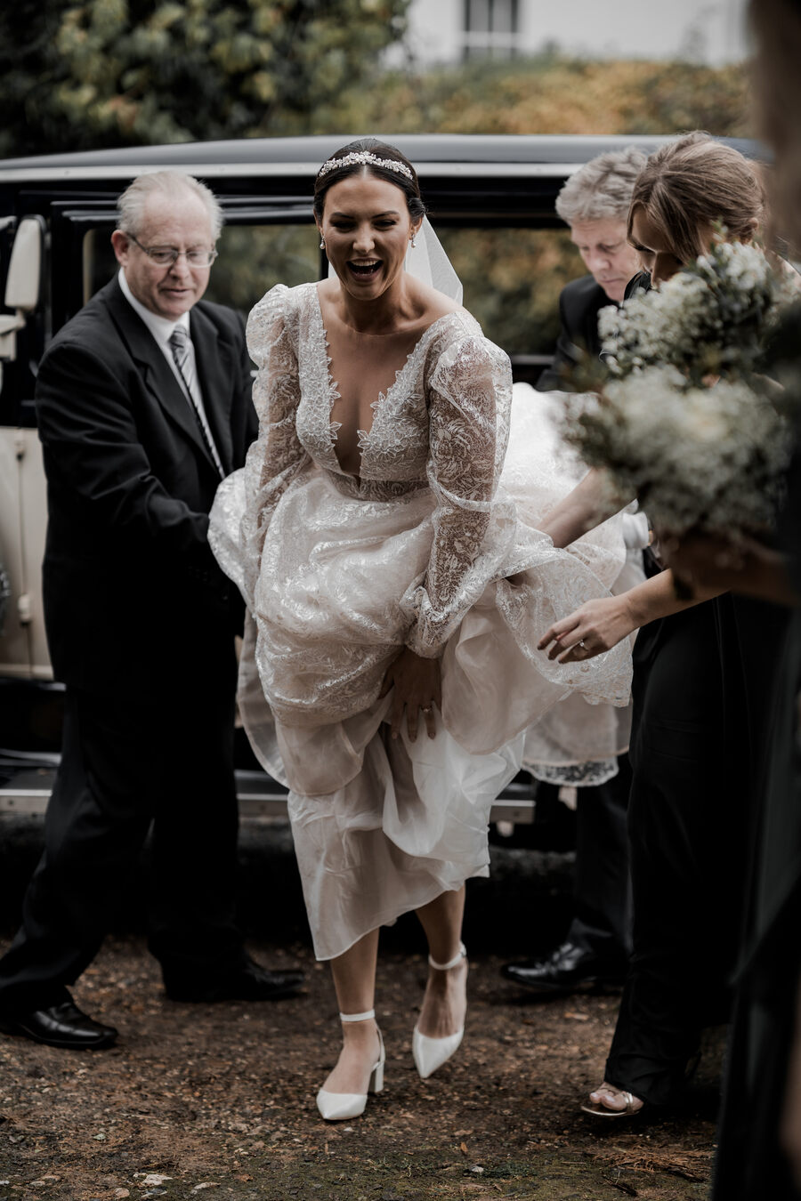 Beautiful bride Gil wearing a stunning Julie Vino long sleeved, puff shouldered, plunging v neck wedding dress with shimmering embroidered embellishments