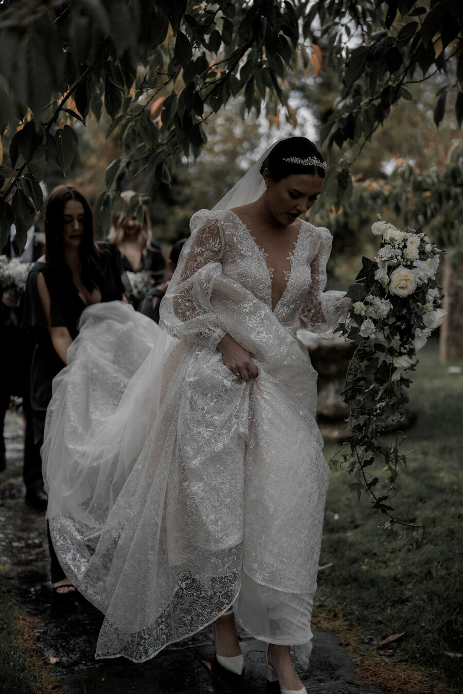 Beautiful bride Gil wearing a stunning Julie Vino long sleeved, puff shouldered, plunging v neck wedding dress with shimmering embroidered embellishments
