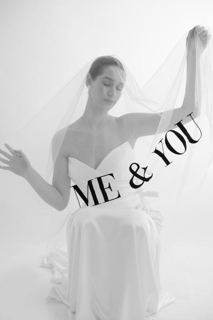 A sheer veil with a bold font in black thread emblazoned across the hem that reads 'Me & You'